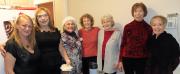 Jane, Rhonda, Jo Anne, Judy G, Gail M, Judy C, & Lisa hang in kitchen